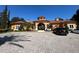 Beautiful clubhouse exterior with an arched entrance and parking at 6169 Metrowest Blvd # 102, Orlando, FL 32835