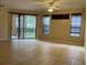 Spacious living room with tiled floors, sliding doors, and windows at 6169 Metrowest Blvd # 102, Orlando, FL 32835
