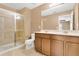 Bathroom featuring a double vanity, white toilet, and glass enclosed shower at 617 Joyful Blossom Pl, Longwood, FL 32750