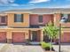 Charming townhome featuring a brick driveway, a one car garage, and inviting curb appeal with landscaping at 617 Joyful Blossom Pl, Longwood, FL 32750