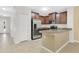 Kitchen boasts stainless steel appliances, brown cabinets, granite countertops, and tile floors at 617 Joyful Blossom Pl, Longwood, FL 32750