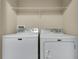 Laundry room with white front loading washer and dryer at 617 Joyful Blossom Pl, Longwood, FL 32750