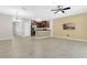 Spacious living room with tile floors, ceiling fan and open floor plan to the kitchen at 617 Joyful Blossom Pl, Longwood, FL 32750