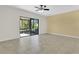 Living room featuring tile floors, a ceiling fan, and sliding glass doors to screened lanai at 617 Joyful Blossom Pl, Longwood, FL 32750