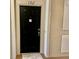 A welcoming black front door with modern hardware and a plush door mat at 6451 Old Park Ln # 102, Orlando, FL 32835