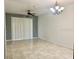Spacious living space with a ceiling fan, tile flooring, and sliding doors to a patio at 6451 Old Park Ln # 102, Orlando, FL 32835