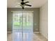 Open living space with neutral paint and tile flooring, featuring large windows at 6451 Old Park Ln # 102, Orlando, FL 32835