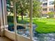 Screened-in patio providing a serene view of the lush, green landscaping at 6451 Old Park Ln # 102, Orlando, FL 32835