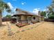 Inviting backyard with a covered patio, gravel landscape, and mature trees at 721 Rock Creek Loop, Longwood, FL 32750