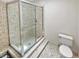 Bathroom features a glass shower with tiled walls, plus a toilet at 721 Rock Creek Loop, Longwood, FL 32750