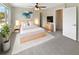 Bright bedroom featuring modern decor, a ceiling fan, bedside tables with lamps, and a neutral color scheme at 721 Rock Creek Loop, Longwood, FL 32750