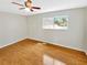 Bedroom with hardwood flooring, ceiling fan, and large window at 721 Rock Creek Loop, Longwood, FL 32750