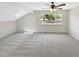 Upstairs bedroom featuring light grey walls, ceiling fan, and big windows at 721 Rock Creek Loop, Longwood, FL 32750