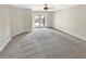 Spacious carpeted bedroom with ceiling fan, light neutral walls, and door to the backyard at 721 Rock Creek Loop, Longwood, FL 32750