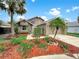 Beautiful home with lush landscaping, palm trees, and a well-maintained lawn at 721 Rock Creek Loop, Longwood, FL 32750
