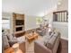 Bright living room with brick fireplace, neutral-toned sofas and hardwood floors at 721 Rock Creek Loop, Longwood, FL 32750