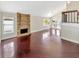 Bright living room featuring a brick fireplace, hardwood floors, and an open layout at 721 Rock Creek Loop, Longwood, FL 32750