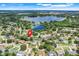 Aerial view of property location near a lake, showing a neighborhood with mature trees and screened pool at 7549 Lake Marsha Dr, Orlando, FL 32819