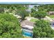 Aerial view of home with screened pool in lush green setting near a lake at 7549 Lake Marsha Dr, Orlando, FL 32819