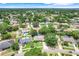 An aerial view of a neighborhood showcasing the home, mature trees, and screened-in pool at 7549 Lake Marsha Dr, Orlando, FL 32819