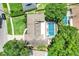Aerial view of the property featuring a private screened-in pool and the surrounding mature trees at 7549 Lake Marsha Dr, Orlando, FL 32819