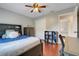 Bedroom showcasing wood floors, a ceiling fan, and a cozy bed with built-in shelving at 7549 Lake Marsha Dr, Orlando, FL 32819