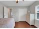 Bright bedroom features hardwood floors, closet, and white dresser for ample storage space at 7549 Lake Marsha Dr, Orlando, FL 32819