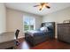 Bedroom featuring wood floors, a ceiling fan, and a cozy bed with built-in shelving at 7549 Lake Marsha Dr, Orlando, FL 32819