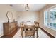 Formal dining room with wood table, seating for six, complemented by a modern light fixture at 7549 Lake Marsha Dr, Orlando, FL 32819