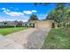 Charming single-story home featuring a large driveway, manicured lawn, and lush landscaping at 7549 Lake Marsha Dr, Orlando, FL 32819