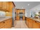 A spacious kitchen with stainless steel appliances and granite countertops, with light wood cabinetry and tile flooring at 7549 Lake Marsha Dr, Orlando, FL 32819