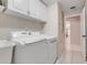 Well-maintained laundry room equipped with appliances and cabinet storage, plus a sink at 7549 Lake Marsha Dr, Orlando, FL 32819