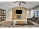 Living room with stone fireplace feature, large screen TV, and comfortable sectional sofa at 7549 Lake Marsha Dr, Orlando, FL 32819