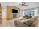 Spacious living room with a stone fireplace, vaulted ceiling, and comfortable sectional sofa at 7549 Lake Marsha Dr, Orlando, FL 32819
