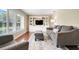Cozy living room featuring a gray sofa, plush ottoman, and built-in shelving at 7549 Lake Marsha Dr, Orlando, FL 32819