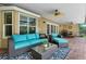 Inviting covered patio with comfortable seating, ceiling fans, and outdoor dining area at 7549 Lake Marsha Dr, Orlando, FL 32819