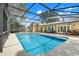 Screened-in pool and patio area with outdoor seating, overlooking lush backyard landscaping at 7549 Lake Marsha Dr, Orlando, FL 32819