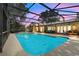 Relaxing screened-in pool with outdoor seating and dining areas, perfect for entertaining at 7549 Lake Marsha Dr, Orlando, FL 32819