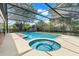 Relaxing screened-in pool area with a cool pool and spa, surrounded by a concrete patio at 7549 Lake Marsha Dr, Orlando, FL 32819