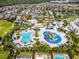 Amazing aerial view showcasing the community waterpark with winding slides, pools, and colorful play structures for all ages at 7739 Graben St, Kissimmee, FL 34747
