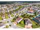 Aerial view highlighting the beautiful property, lush landscaping, red-tiled roof, and surrounding neighborhood at 7739 Graben St, Kissimmee, FL 34747