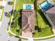 Aerial view showcasing the roof, pool, and lush landscaping of this beautiful property at 7739 Graben St, Kissimmee, FL 34747