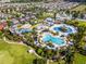 Aerial view of a waterpark resort featuring pools, slides, cabanas, and lush landscaping at 7739 Graben St, Kissimmee, FL 34747