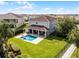 Spacious backyard with a pool, hot tub, covered patio, and manicured landscaping at 7739 Graben St, Kissimmee, FL 34747