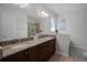 Bright bathroom with double vanity, granite countertops, and a glass shower at 7739 Graben St, Kissimmee, FL 34747