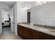 Elegant bathroom features a double vanity with granite countertop and tiled floor at 7739 Graben St, Kissimmee, FL 34747
