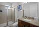 Bathroom with granite topped vanity, glass shower, and neutral tones at 7739 Graben St, Kissimmee, FL 34747