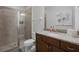 Updated bathroom showcasing a glass-enclosed shower, granite vanity and modern fixtures at 7739 Graben St, Kissimmee, FL 34747