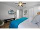 Bedroom boasting a ceiling fan, ensuite access, a TV, bench, and neutral decor for a serene vibe at 7739 Graben St, Kissimmee, FL 34747