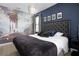 Themed bedroom with dark blue accent wall and interesting wallpaper at 7739 Graben St, Kissimmee, FL 34747
